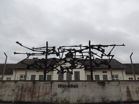 This sculpture, located in front of the camp's headquarters, serves as a memorial to the fallen souls of Dachau. The sculpture resembles barbed wire upon first glance but the pieces are made to look like human bones. The date inscription under the statue indicates the years during which Dachau was utilized, starting with the rise of the Nazi party in 1933 and ending in 1945 when American troops liberated the camp.